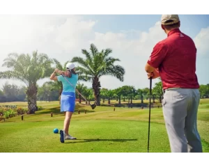 Golfer teeing off on a tropical golf course