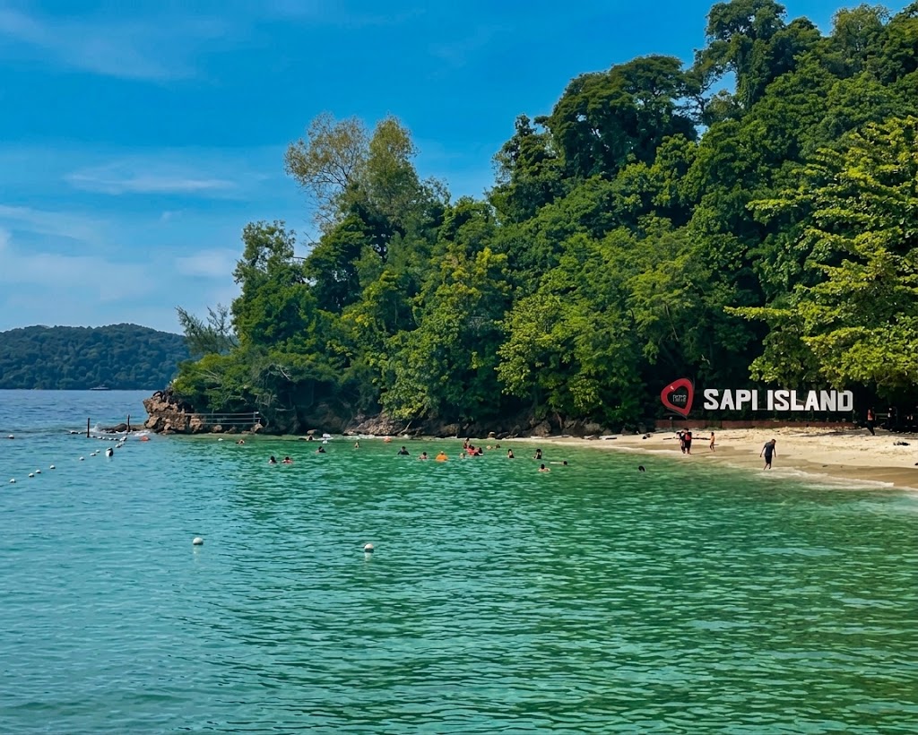 Sapi Island sign beside clear tropical water