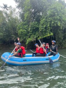 Rafting group paddling through calm river water