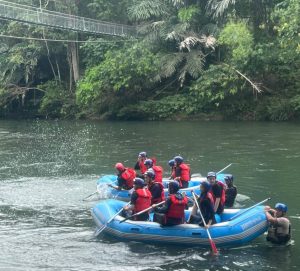 Guests white-water rafting on a rainforest river