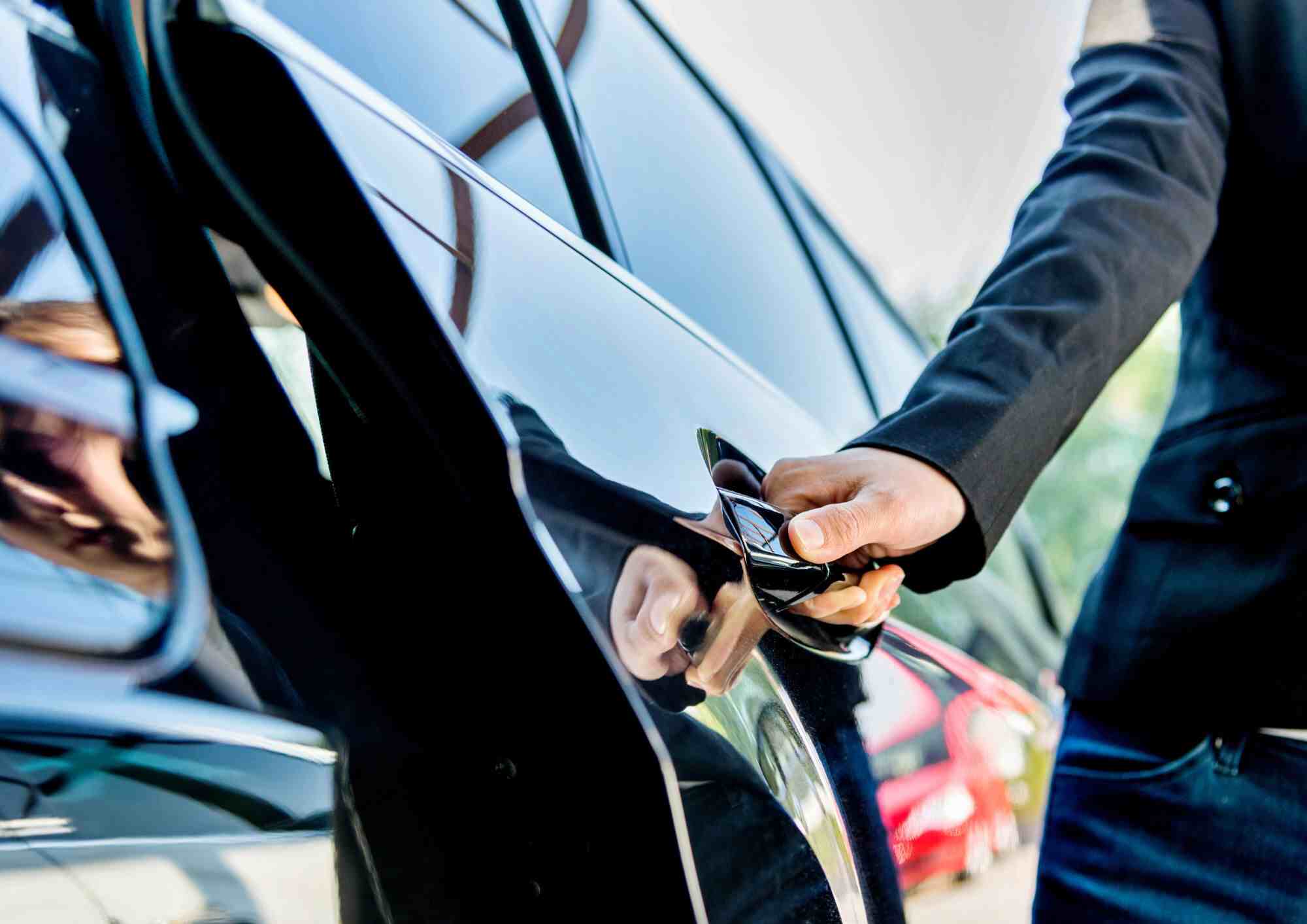 Passenger opening the door of a tour vehicle