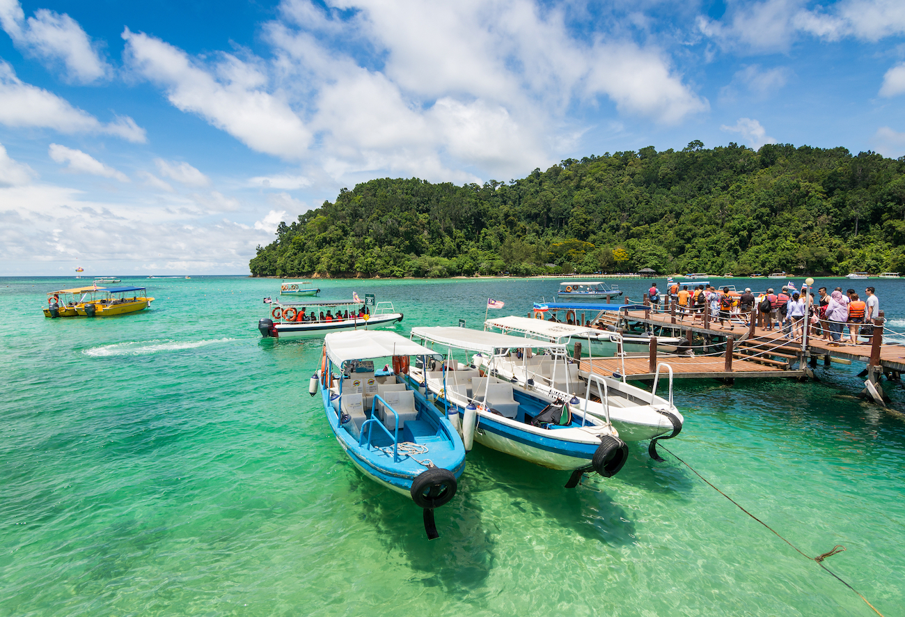 Boats moored at a tropical island jetty